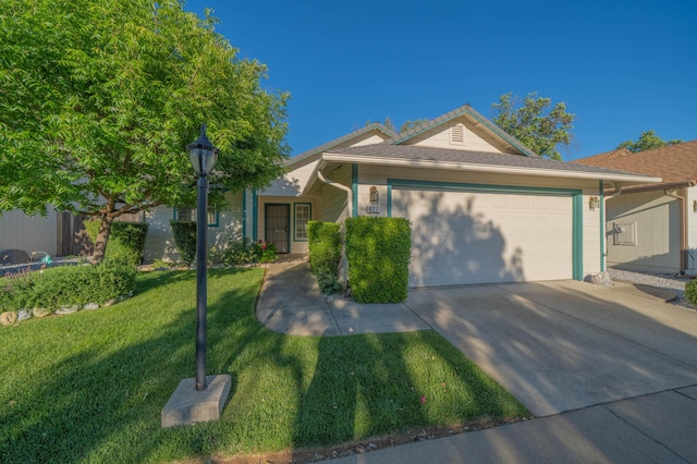 ranch-style house with a garage, a front yard, and concrete driveway