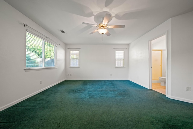carpeted spare room with healthy amount of natural light, baseboards, and a ceiling fan