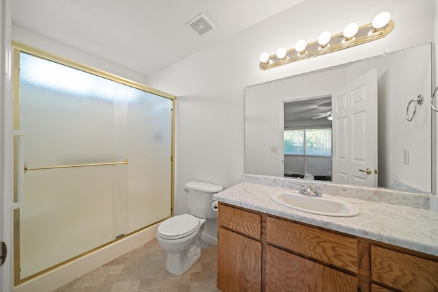 full bathroom featuring a shower stall, toilet, vanity, and baseboards