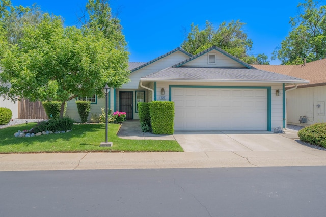 427 Yolla Bolly Trl, Redding, CA 96003 - ranch-style house featuring an attached garage, concrete driveway, and a front lawn