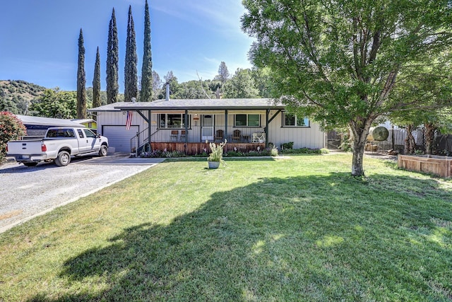 14851 Ravine Rd, Redding, CA 96003 - ranch-style house with covered porch, driveway, and a front yard