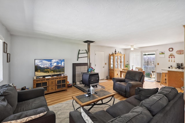 14851 Ravine Rd, Redding, CA 96003 - living room featuring light wood-style flooring and a wood stove