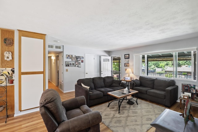 14851 Ravine Rd, Redding, CA 96003 - living area with light wood-style floors and a textured ceiling