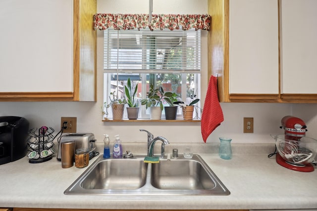 14851 Ravine Rd, Redding, CA 96003 - kitchen with a sink, light countertops, and white cabinetry