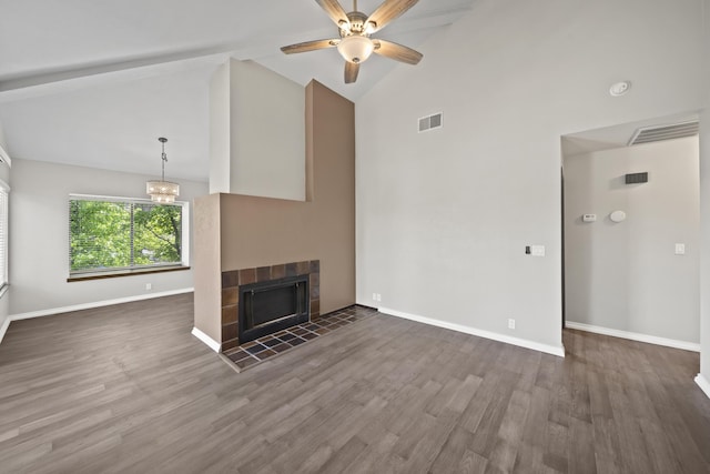 426 Ridgecrest Trl Unit 223, Redding, CA 96003 - unfurnished living room with high vaulted ceiling, a tile fireplace, dark wood finished floors, ceiling fan, and a chandelier