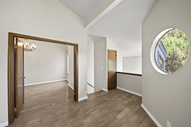 426 Ridgecrest Trl Unit 223, Redding, CA 96003 - unfurnished room with vaulted ceiling, a chandelier, and wood finished floors