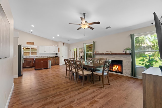 1946 Jeanae Ct, Redding, CA 96002 - dining area with lofted ceiling, a ceiling fan, a lit fireplace, wood finished floors, and recessed lighting