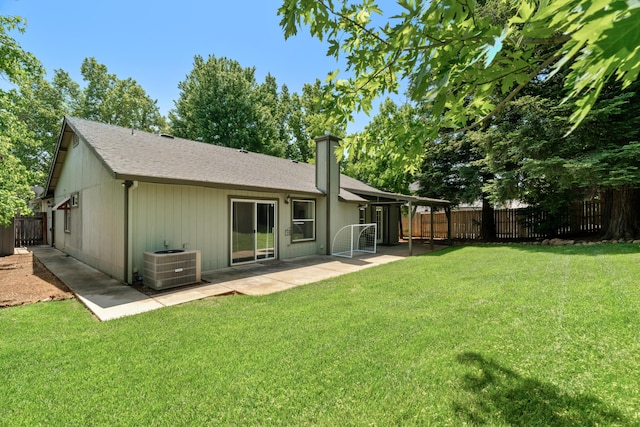 1946 Jeanae Ct, Redding, CA 96002 - rear view of house featuring central AC, a patio, roof with shingles, and a chimney