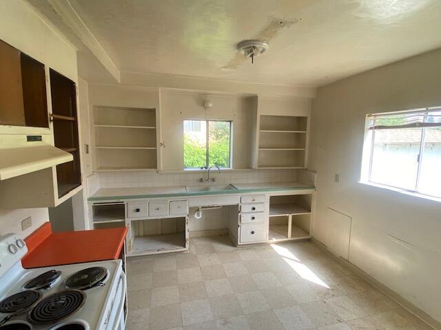 unfurnished office with a sink and light flooring