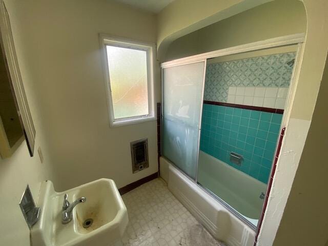 bathroom featuring tile patterned floors, combined bath / shower with glass door, and heating unit