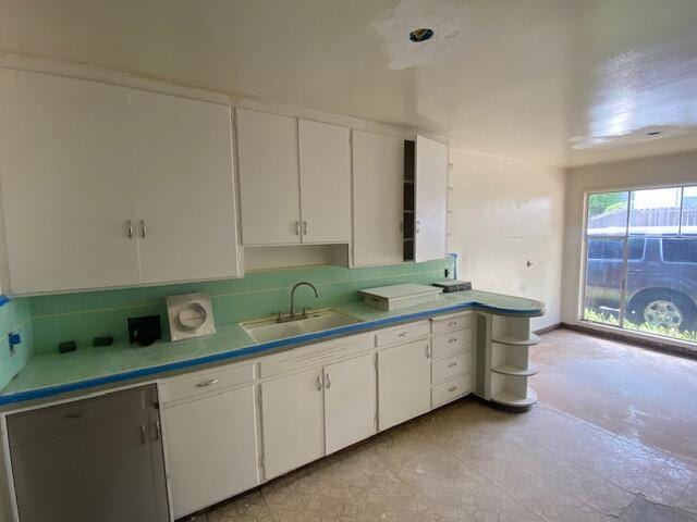kitchen featuring a sink and white cabinets