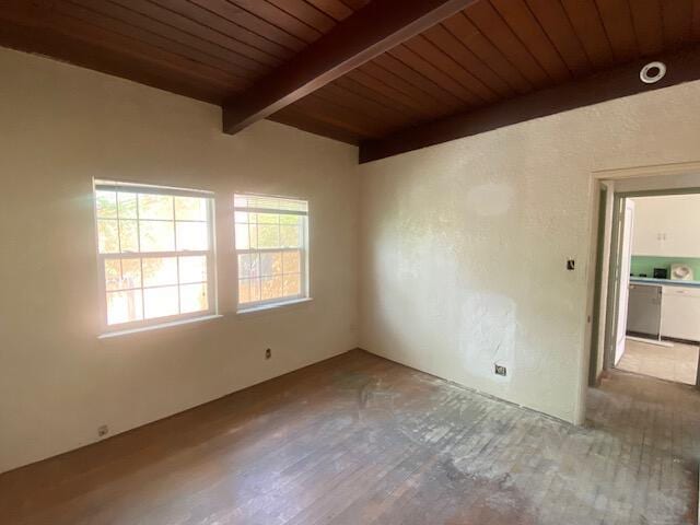 empty room with beam ceiling, wooden ceiling, and wood finished floors