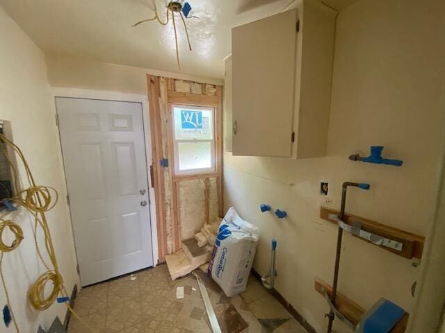 clothes washing area with light floors