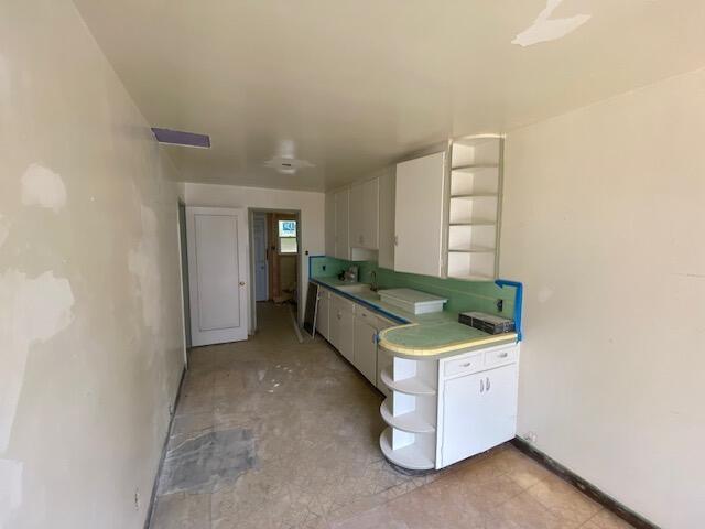 1170-1176 Orange Ave, Redding, CA 96001 - kitchen featuring open shelves, white cabinets, and a sink
