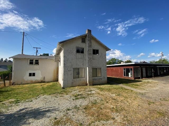 back of house featuring a lawn