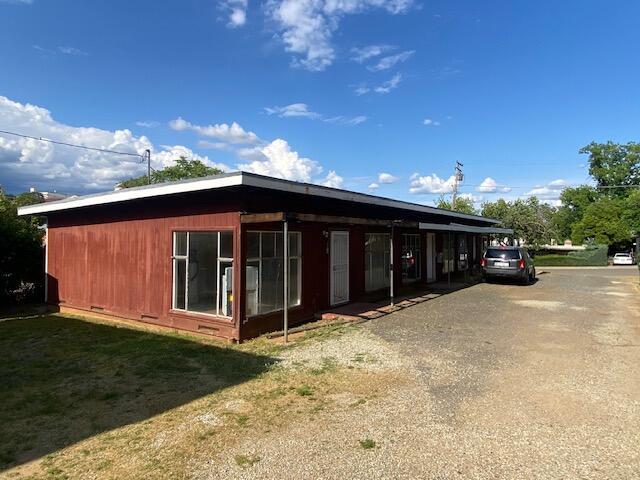 view of side of property featuring crawl space and driveway