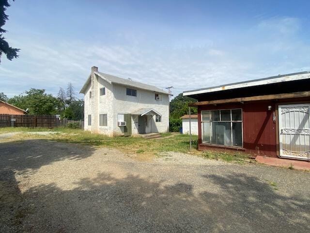 rear view of house with fence