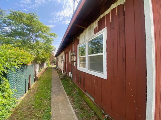 view of home's exterior with fence