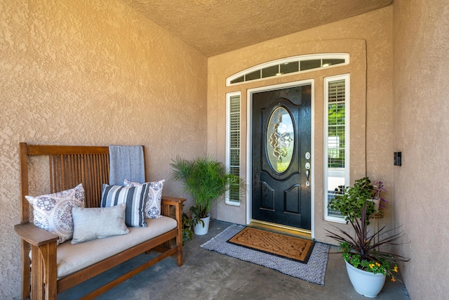 view of exterior entry featuring stucco siding