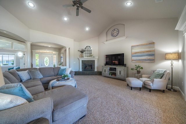 living room with ornate columns, arched walkways, carpet, a ceiling fan, and vaulted ceiling