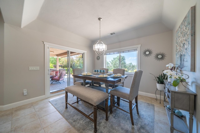 dining room with a chandelier, plenty of natural light, and light tile patterned flooring