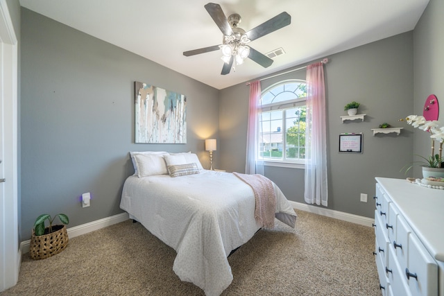 bedroom featuring light colored carpet, baseboards, and a ceiling fan