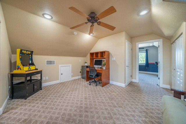 office space featuring carpet flooring, vaulted ceiling, a ceiling fan, and baseboards