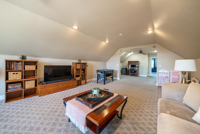 carpeted living area featuring vaulted ceiling and baseboards