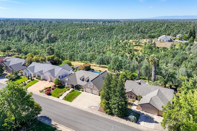 aerial perspective of suburban area featuring a heavily wooded area