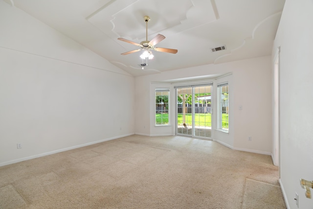 empty room featuring carpet flooring, ceiling fan, baseboards, and lofted ceiling