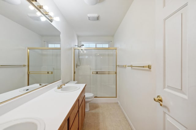 bathroom featuring a shower stall, double vanity, baseboards, toilet, and tile patterned floors