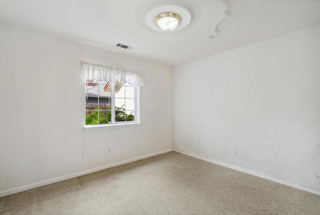 unfurnished room with carpet and baseboards