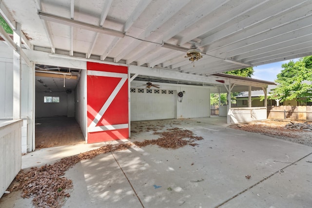 garage with fence and a ceiling fan