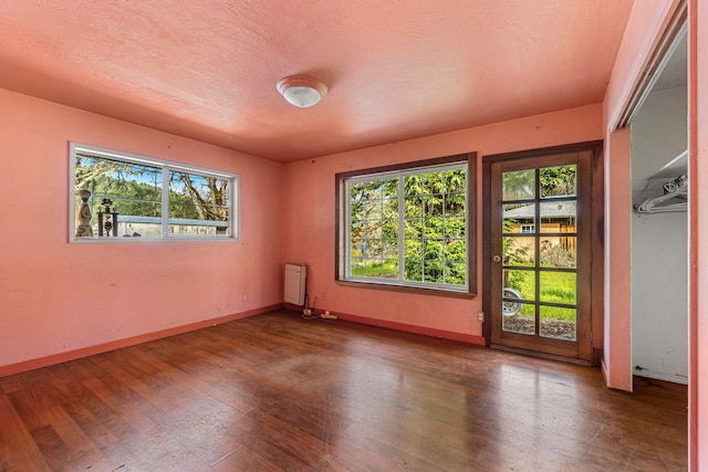 8686 Bell Springs Rd, Garberville, CA 95542 - spare room featuring wood finished floors, radiator, and baseboards