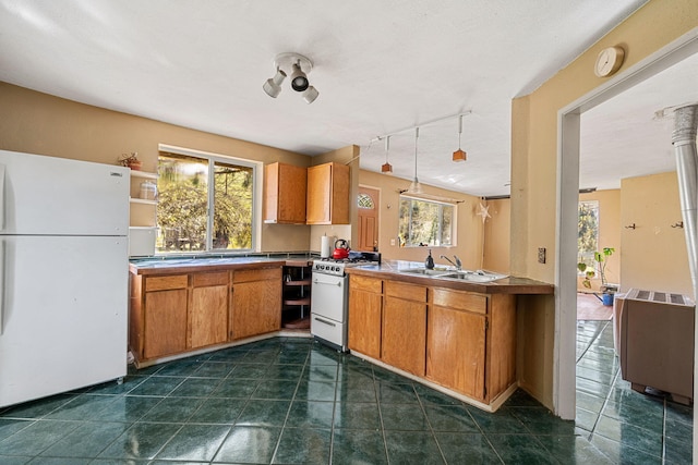 8686 Bell Springs Rd, Garberville, CA 95542 - kitchen featuring white appliances, a sink, healthy amount of natural light, and brown cabinets