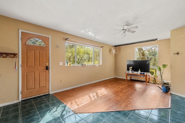 8686 Bell Springs Rd, Garberville, CA 95542 - foyer entrance featuring ceiling fan, dark tile patterned floors, and baseboards