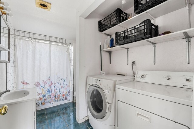 8686 Bell Springs Rd, Garberville, CA 95542 - washroom featuring independent washer and dryer, dark tile patterned flooring, and baseboards