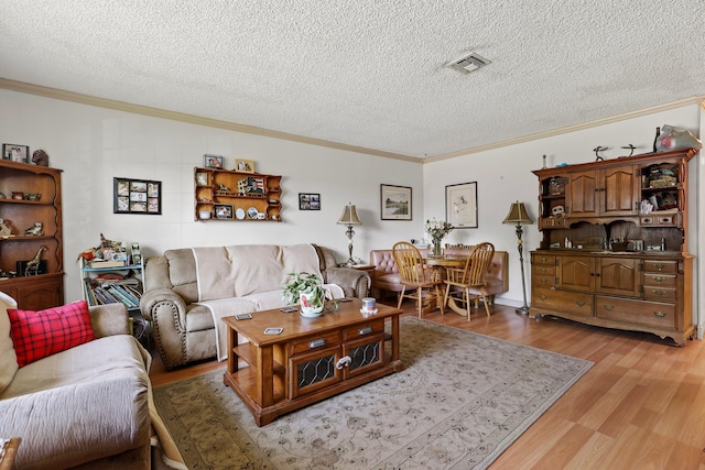 2350 Christian Ave, Redding, CA 96002 - living area with crown molding, light wood-type flooring, and a textured ceiling