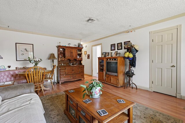 2350 Christian Ave, Redding, CA 96002 - living area featuring crown molding, light wood-style flooring, and a textured ceiling