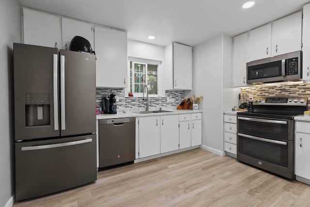 2350 Christian Ave, Redding, CA 96002 - kitchen with stainless steel appliances, a sink, light countertops, white cabinets, and recessed lighting