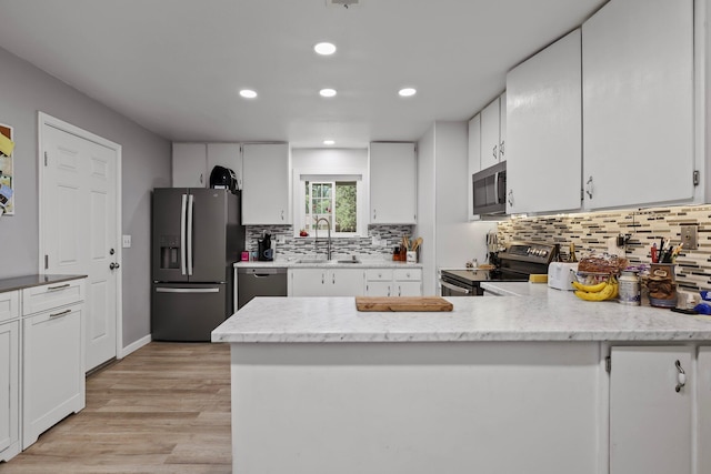 2350 Christian Ave, Redding, CA 96002 - kitchen with stainless steel appliances, a sink, decorative backsplash, white cabinetry, and recessed lighting