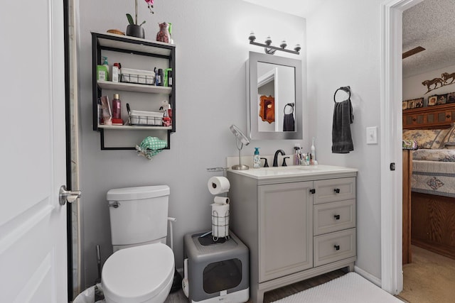 2350 Christian Ave, Redding, CA 96002 - bathroom with vanity, toilet, and a textured ceiling