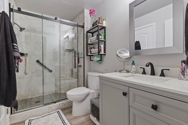 2350 Christian Ave, Redding, CA 96002 - bathroom with toilet, vanity, a shower stall, and wood finished floors