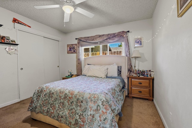 2350 Christian Ave, Redding, CA 96002 - carpeted bedroom featuring a closet, a textured ceiling, baseboards, and ceiling fan