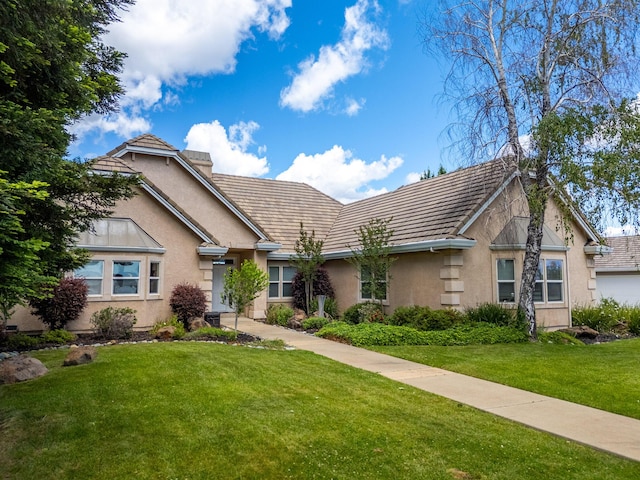 831 Santa Cruz Dr, Redding, CA 96003 - view of front of house with stucco siding, a front yard, and a tile roof