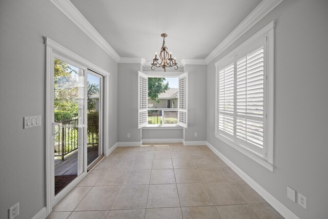831 Santa Cruz Dr, Redding, CA 96003 - unfurnished dining area with a chandelier, healthy amount of natural light, ornamental molding, light tile patterned flooring, and baseboards