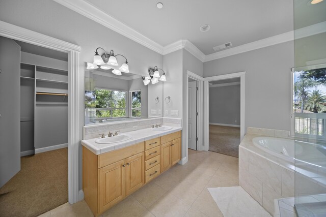 831 Santa Cruz Dr, Redding, CA 96003 - bathroom featuring crown molding, double vanity, tile patterned flooring, a garden tub, and baseboards