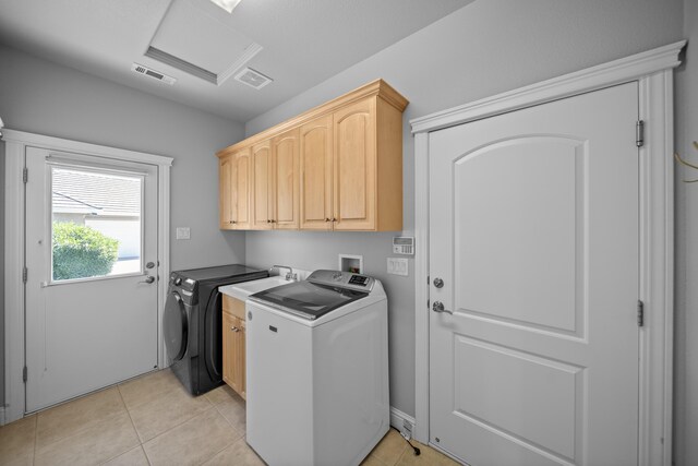 831 Santa Cruz Dr, Redding, CA 96003 - laundry area featuring cabinet space, washing machine and clothes dryer, attic access, and light tile patterned floors