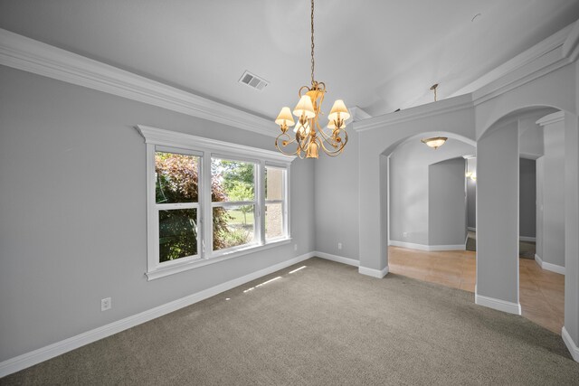 831 Santa Cruz Dr, Redding, CA 96003 - spare room with arched walkways, a chandelier, carpet, crown molding, and baseboards