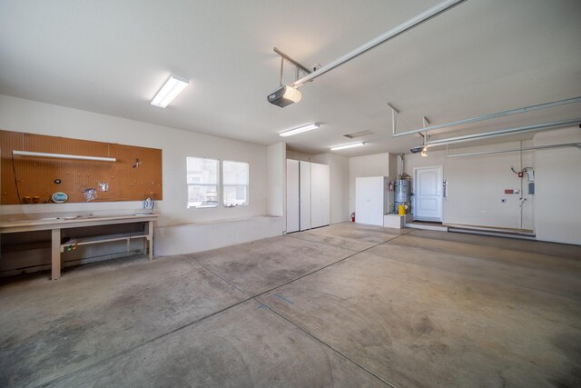 831 Santa Cruz Dr, Redding, CA 96003 - garage featuring a garage door opener, water heater, and a workshop area